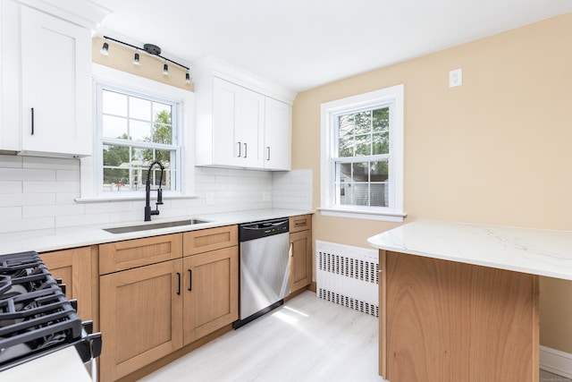 57 Saint James St, West Hartford, CT 06119 - kitchen featuring stainless steel dishwasher, a sink, radiator, light wood-style floors, and backsplash