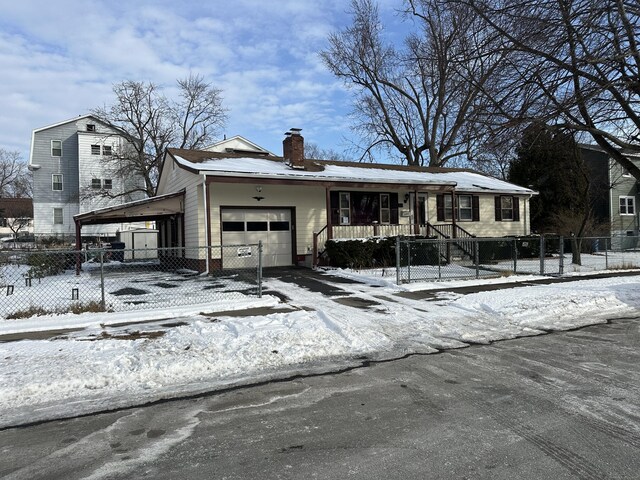 view of front of home featuring a carport, a garage, and covered porch