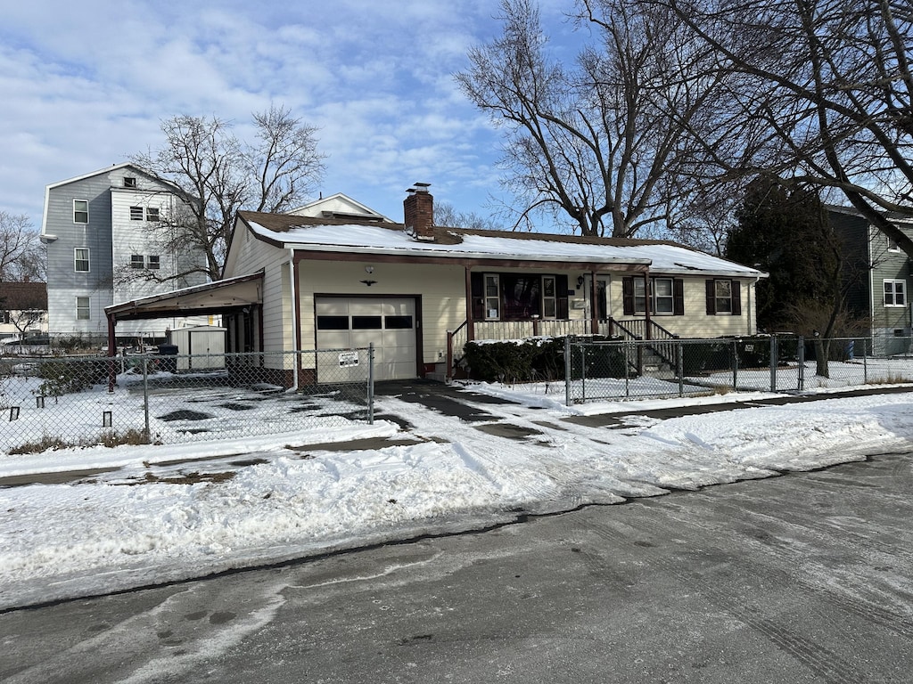 view of front of house featuring a garage, a carport, and covered porch