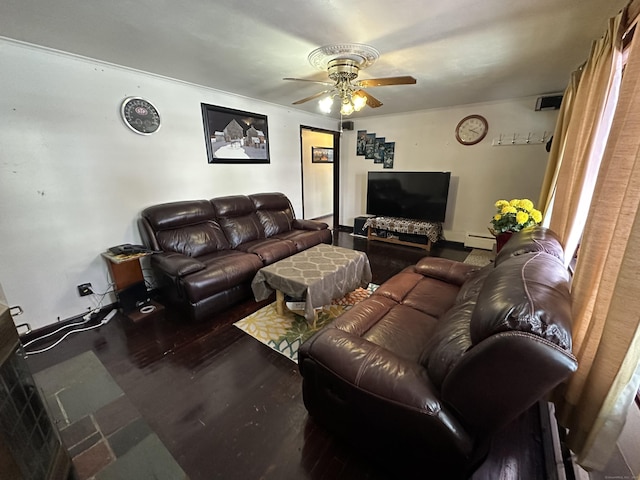 living room featuring a baseboard heating unit, hardwood / wood-style floors, and ceiling fan