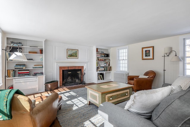 9 Mallory Brook Rd, Washington, CT 06793 - living room featuring a fireplace, built in shelves, and radiator