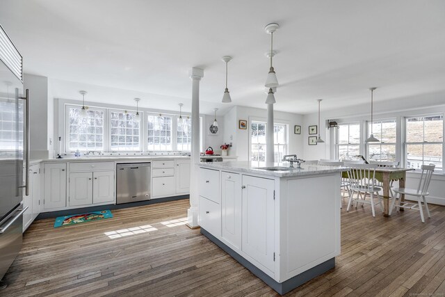 9 Mallory Brook Rd, Washington, CT 06793 - kitchen with stainless steel appliances, wood finished floors, white cabinets, pendant lighting, and a sink