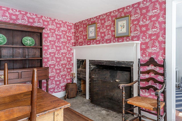 interior space featuring wallpapered walls and a fireplace