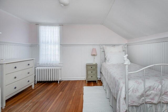 9 Mallory Brook Rd, Washington, CT 06793 - bedroom featuring radiator heating unit, hardwood / wood-style flooring, wainscoting, and vaulted ceiling