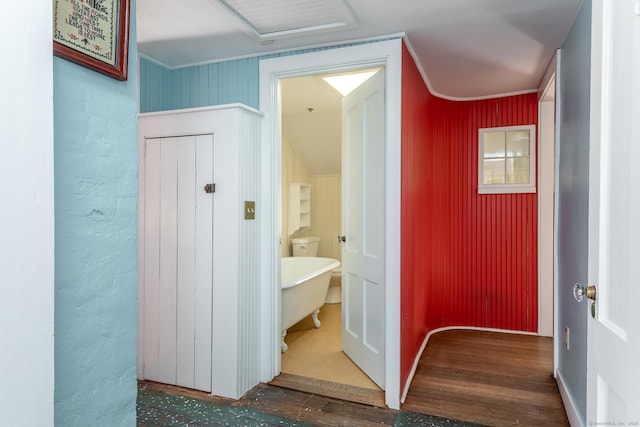 bathroom featuring a freestanding tub and wood finished floors