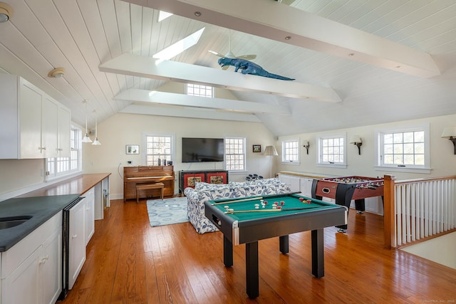 playroom with lofted ceiling with skylight, pool table, a sink, and light wood-style flooring