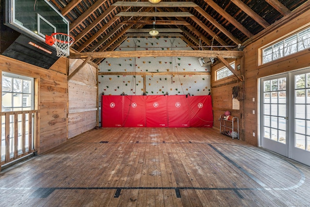 interior space featuring hardwood / wood-style floors, plenty of natural light, and wooden walls