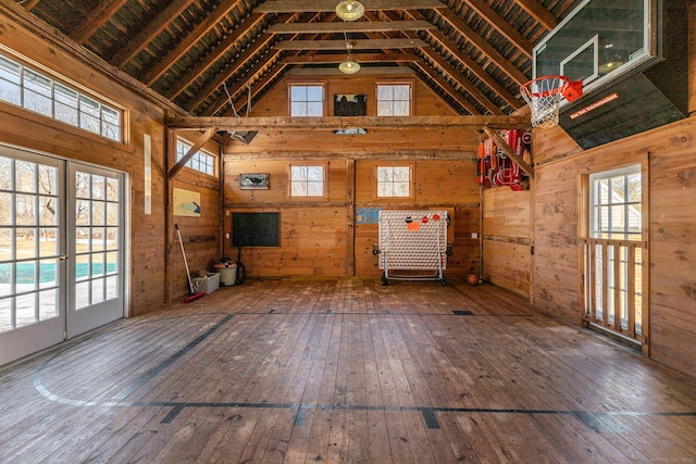 9 Mallory Brook Rd, Washington, CT 06793 - unfurnished living room with wood walls, hardwood / wood-style floors, and high vaulted ceiling