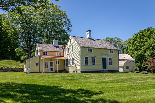 9 Mallory Brook Rd, Washington, CT 06793 - back of house featuring a chimney, a lawn, and entry steps