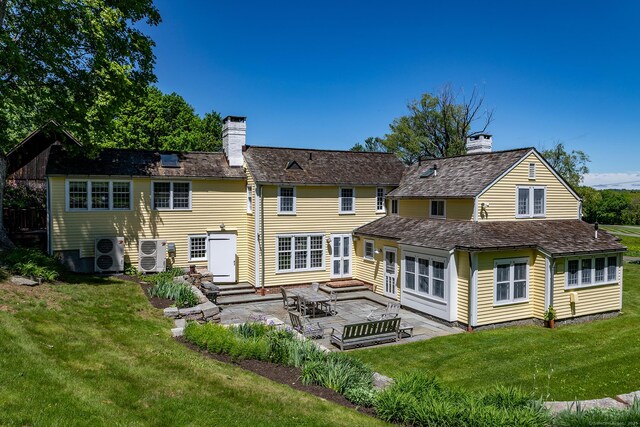 9 Mallory Brook Rd, Washington, CT 06793 - rear view of house with a chimney, a patio area, and a lawn