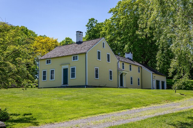9 Mallory Brook Rd, Washington, CT 06793 - view of front facade with a chimney, a front yard, and a garage