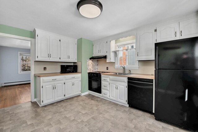 kitchen featuring baseboard heating, white cabinets, sink, and black appliances