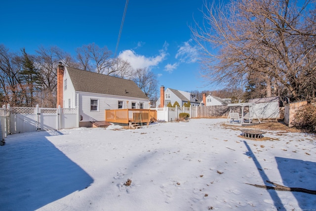 snow covered property with a wooden deck