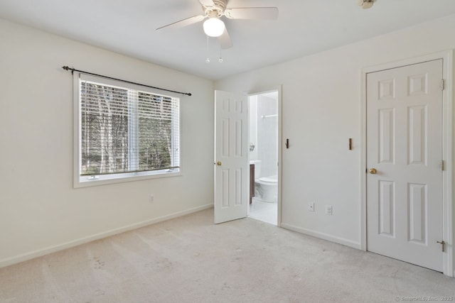 unfurnished bedroom featuring ensuite bath, ceiling fan, baseboards, and carpet