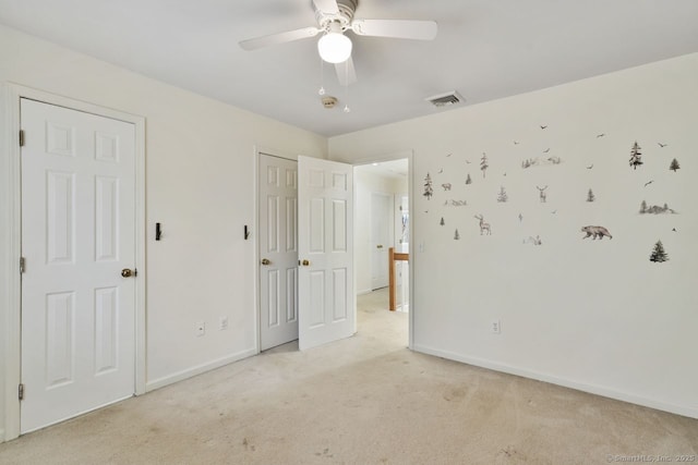 unfurnished bedroom with a ceiling fan, light colored carpet, visible vents, and baseboards