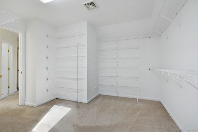 walk in closet with visible vents and carpet flooring