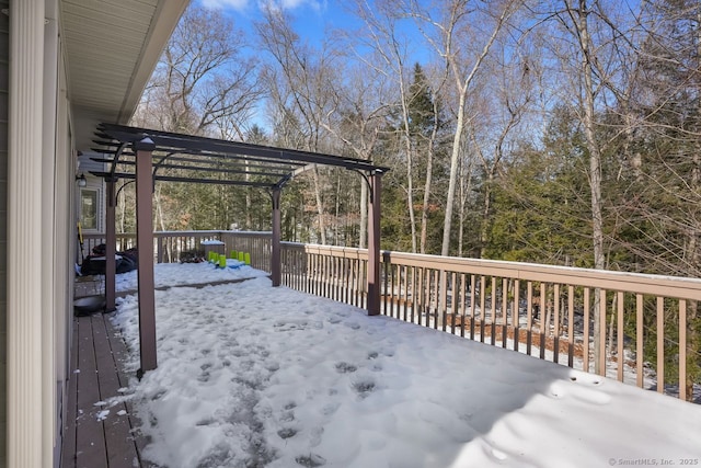 snow covered deck featuring a pergola