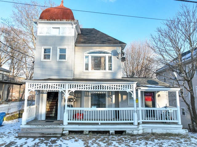 snow covered house with covered porch