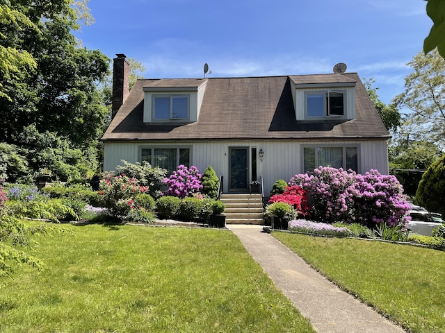 cape cod-style house with a front lawn