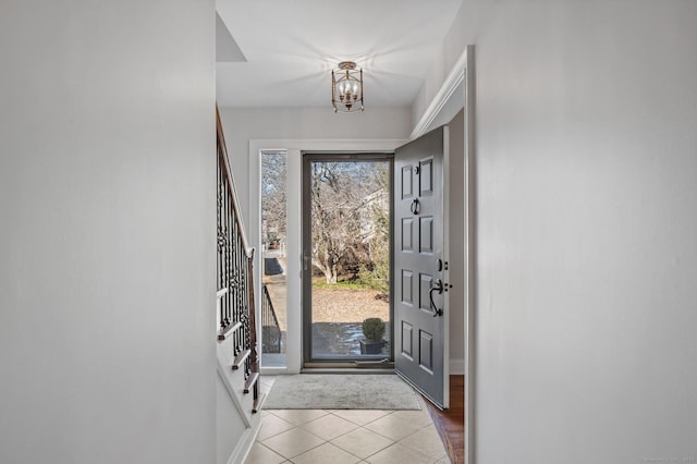 entrance foyer featuring a notable chandelier and light tile patterned flooring