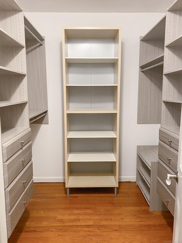 walk in closet featuring dark hardwood / wood-style flooring