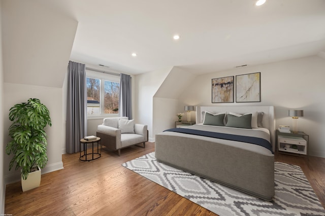 bedroom featuring wood-type flooring and lofted ceiling