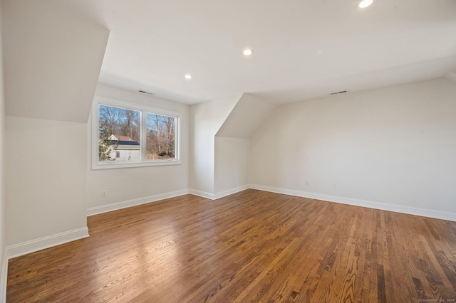 bonus room featuring wood-type flooring and vaulted ceiling