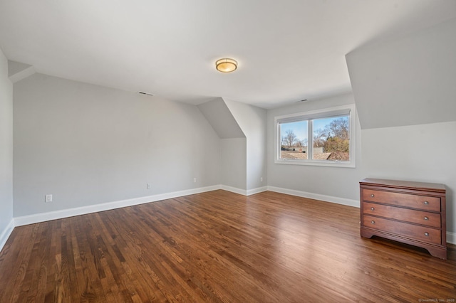 bonus room featuring lofted ceiling and dark hardwood / wood-style flooring