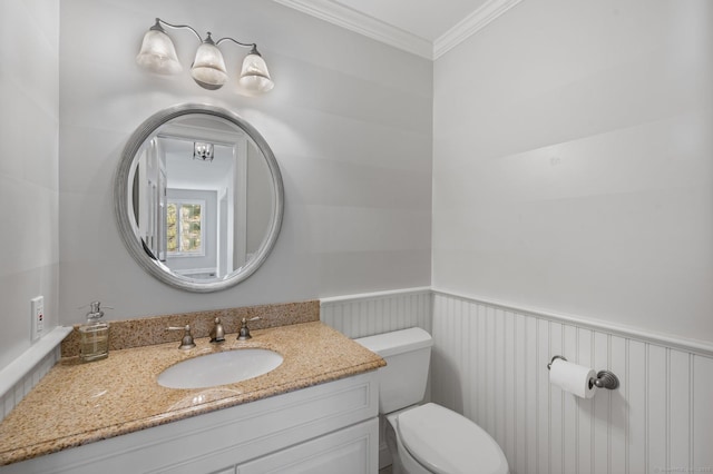 bathroom featuring crown molding, vanity, and toilet