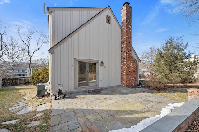 rear view of house with a patio and central AC