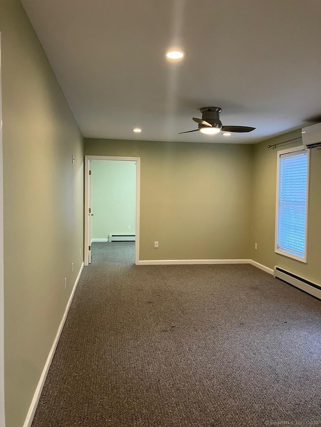 carpeted empty room with ceiling fan, a wall mounted air conditioner, and baseboard heating