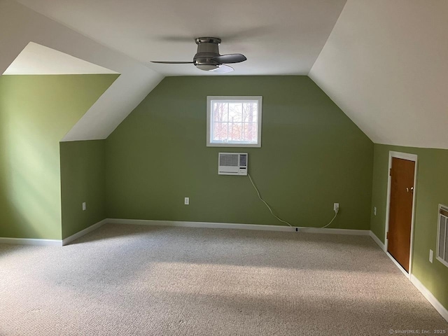 bonus room with lofted ceiling, a wall mounted AC, and carpet floors