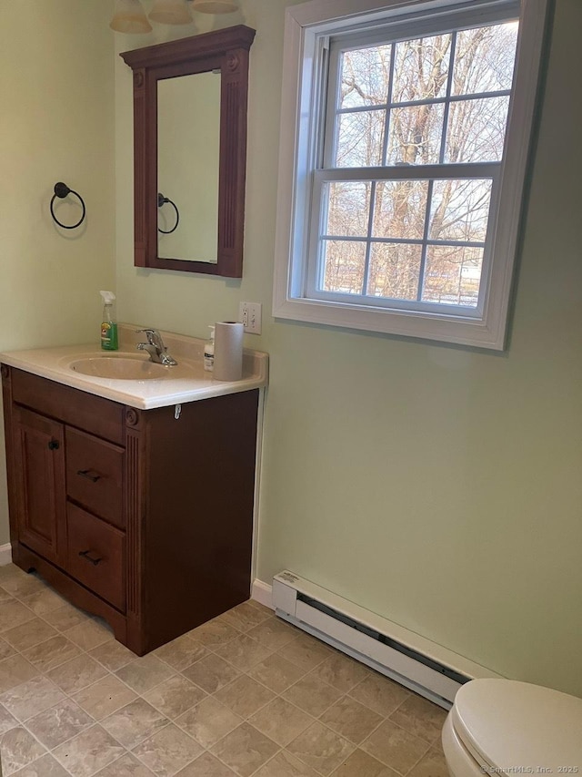 bathroom featuring vanity, a baseboard radiator, and toilet