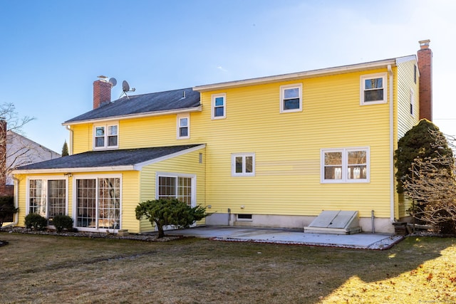 rear view of house with a yard and a patio area