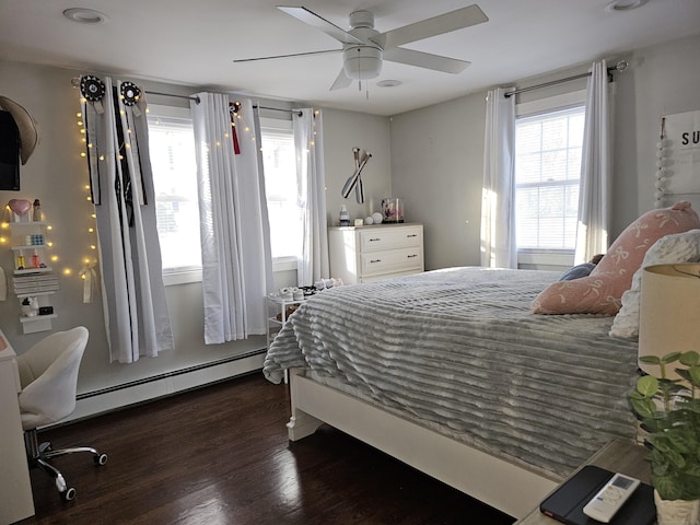 bedroom featuring ceiling fan, dark hardwood / wood-style floors, and baseboard heating