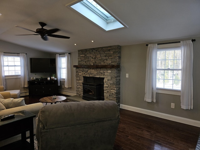 living room with vaulted ceiling, plenty of natural light, a baseboard heating unit, and dark hardwood / wood-style floors