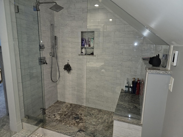 bathroom featuring a shower with door