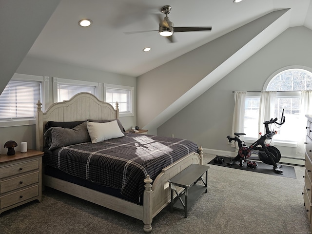 carpeted bedroom featuring a baseboard heating unit, vaulted ceiling, and ceiling fan