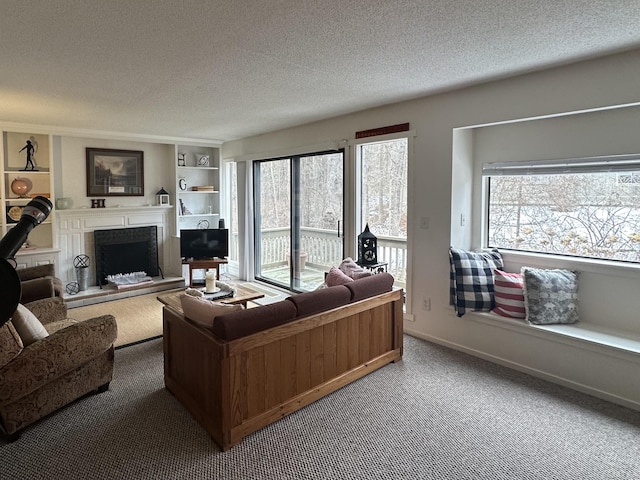 living room with carpet floors, a textured ceiling, and built in shelves