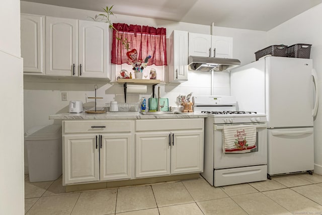 kitchen featuring white cabinetry, white appliances, sink, and light tile patterned floors