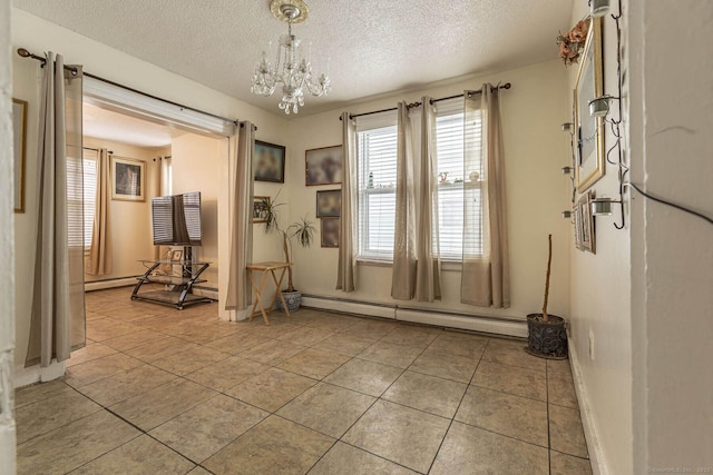 interior space featuring light tile patterned floors, a baseboard radiator, a chandelier, and a textured ceiling