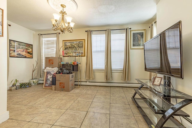 dining room with light tile patterned flooring, a chandelier, a textured ceiling, and a baseboard heating unit