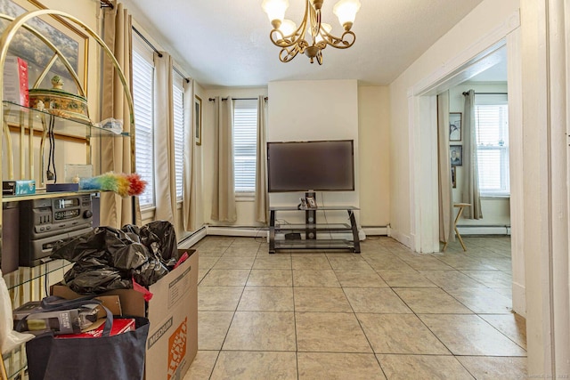 tiled living room with a baseboard heating unit and a notable chandelier