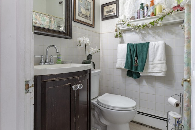 bathroom featuring vanity, toilet, and tile walls