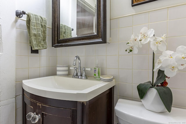 bathroom featuring vanity and tile walls