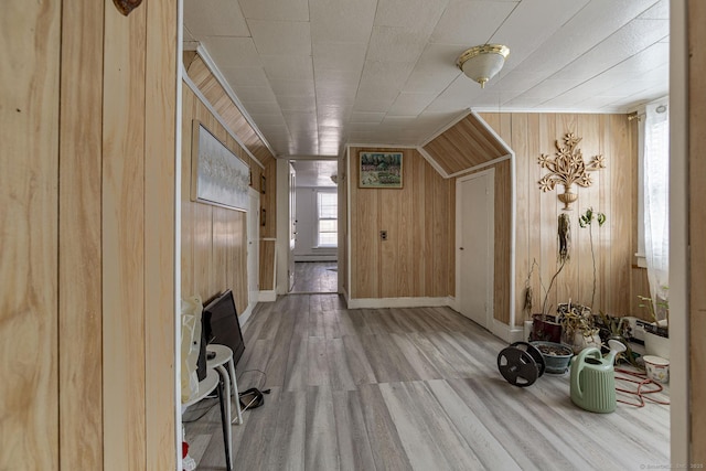 entryway with hardwood / wood-style flooring and wood walls