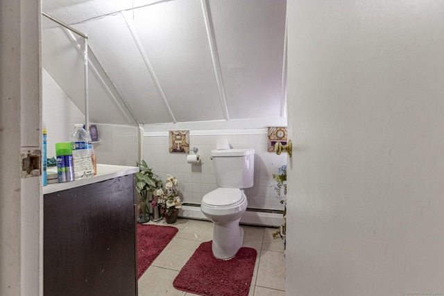 bathroom with tile patterned flooring, vaulted ceiling, toilet, and baseboard heating