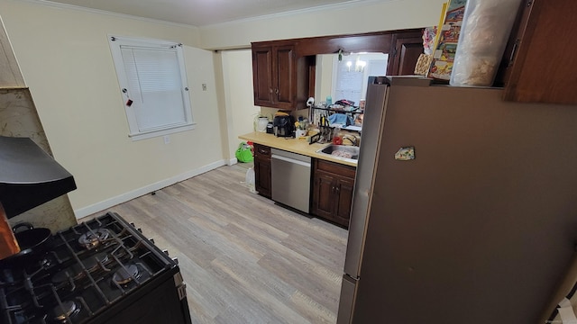 kitchen featuring sink, crown molding, light hardwood / wood-style flooring, and appliances with stainless steel finishes