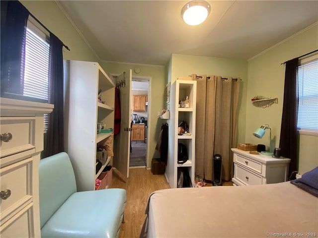 bedroom featuring ornamental molding and light hardwood / wood-style floors