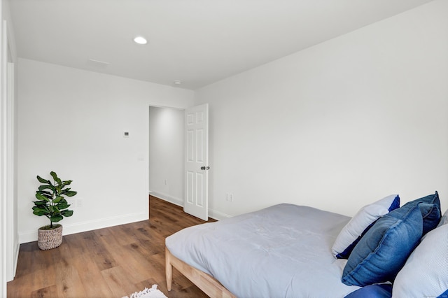 bedroom with hardwood / wood-style floors